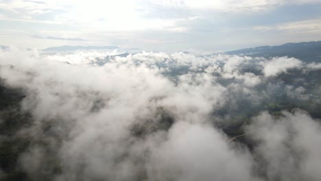 Aerial-flight-over-low-lying-clouds,-scenic-skyscape-background