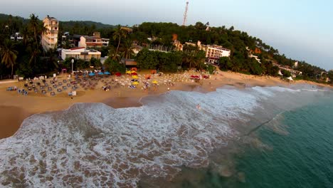 Slow-Motion-Pull-Back-Shot-Of-Huge-Wave-Splashing-On-Tropical-Beach,-Sri-Lanka