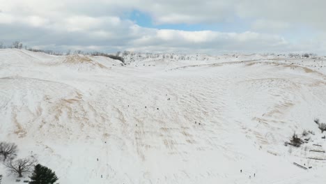 Fixed-Aerial-View-of-People-Sledding-at-Sleeping-Bear-Dunes-National-Park