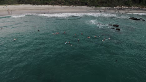 Aerial-View-Of-Surfers-Enjoying-At-The-Beach-In-Puerto-Escondido,-Oaxaca,-Mexico---drone-shot
