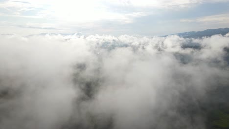 Flight-over-low-clouds,-scenic-view-over-skyscape,-aerial-pull-away-reveal