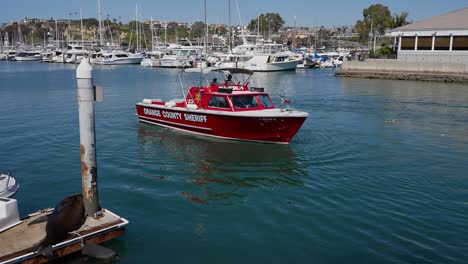 Orange-County-Sheriff-boat-turning-in-Dana-Point-Harbor,-in-Southern-California