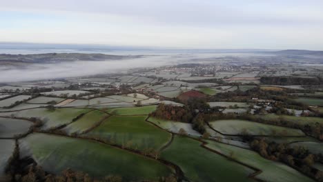 Aerial-parallax-shot-of-the-Otter-Valley-in-Devon-England-on-a-frosty-winters-morning