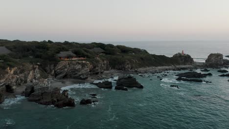 Rugged-Cliffs-And-Rock-Formations-At-The-Ocean-In-Puerto-Escondido,-Mexico---aerial-drone-shot