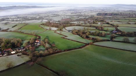 Aerial-rising-shot-over-English-Countryside-to-reveal-River-Mist-on-a-frosty-winters-morning