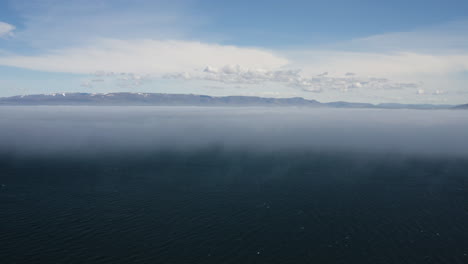 AERIAL---Beautiful-blue-horizon-above-Hvitserkur,Vatnsnes,-Iceland,-descending