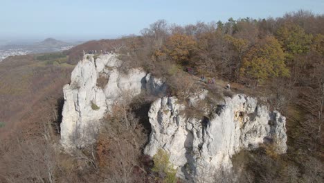 Aerial-view-zooming-out-of-climbing-rock-and-forest-in-Swabian-Alb,-Germany