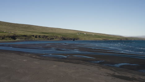 AERIAL---Natural-coastline-in-Hvitserkur,Vatnsnes,-Iceland,-low-angle-forward