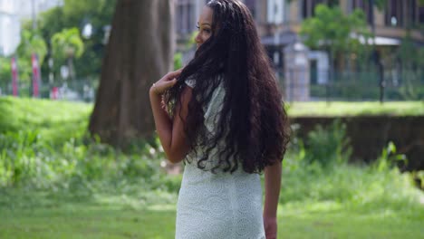 Young-long-natural-hair-girl-walking-in-the-park-before-turning-around-to-reveal-a-pretty-face