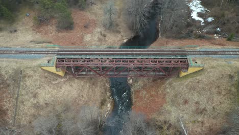 AERIAL:-Old-Metal-Bridge-Constructed-Over-Flowing-River-in-Eastern-Europe
