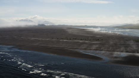 AERIAL---Approaching-coastline-in-Hvitserkur,Vatnsnes,-Iceland,-wide-shot-forward