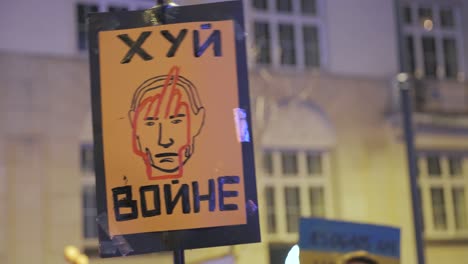 2022-Russia-invasion-of-Ukraine---poster-"fuck-with-war"-at-an-anti-war-demonstration-in-Warsaw-on-the-very-first-day-of-the-war