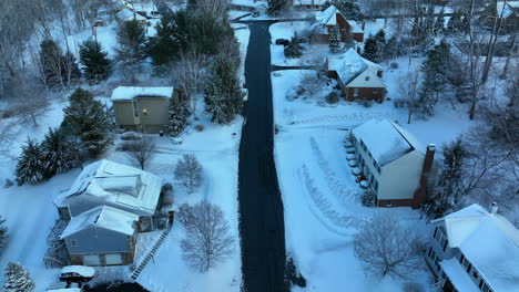 Descending-aerial-on-homes-and-lawn-yards-covered-in-fresh-winter-snow