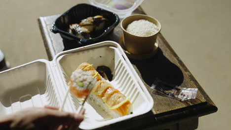 Starting-to-eat-Sushi-entree-roll-rice-eel-sashimi-chopsticks-4K