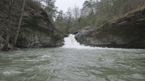 Slow-motion-footage-of-small-waterfall-flowing-into-lake-at-Lula-Lake-Land-Trust-in-Chattanooga,-TN