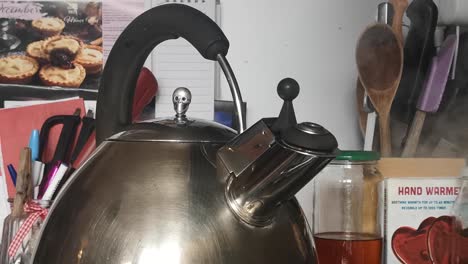 Real-time-whistling-kettle-with-skull-lid-boiling-steam-vapor-on-kitchen-stove