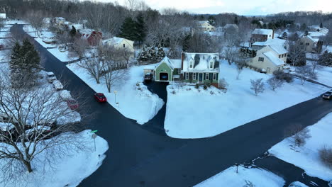 Green-Cape-Cod-home-covered-in-winter-snow