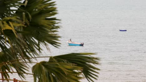 Zwei-Kleine-Boote-Im-Wasser-Mit-Einer-Palme-Im-Vordergrund-Vor-Der-Küste-Von-Pattaya,-Thailand