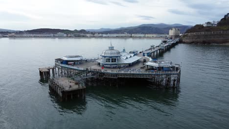 Elegant-stretching-Victorian-Welsh-Llandudno-pier-aerial-over-flying-view-on-quiet-morning