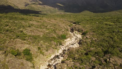 Aerial-forward-over-dry-river,-Cordoba-province.-Argentina