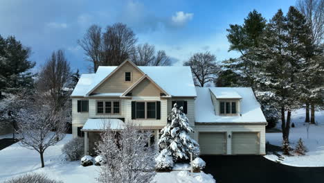 Two-story-family-home-and-garage,-driveway-in-USA-covered-in-fresh-winter-snow