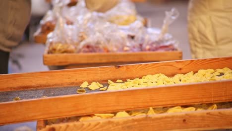 Close-up-of-orecchiette-pasta-being-sold-at-local-Italian-market