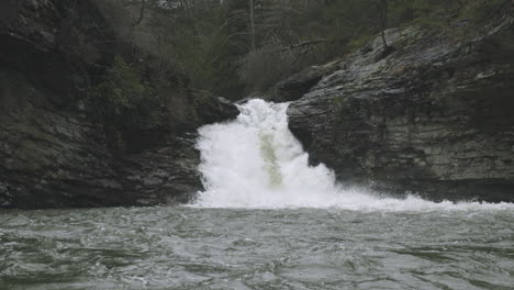 Close-up-footage-of-small-waterfall-flowing-into-lake-in-Chattanooga,-TN