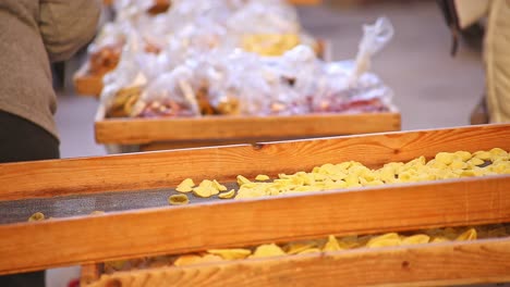 Italian-lady-selling-and-preparing-orecchiette-pasta-at-local-market