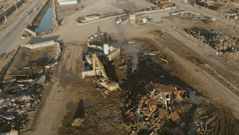Aerial-shot-of-smoking-equipment-in-junkyard-in-Nashville,-TN