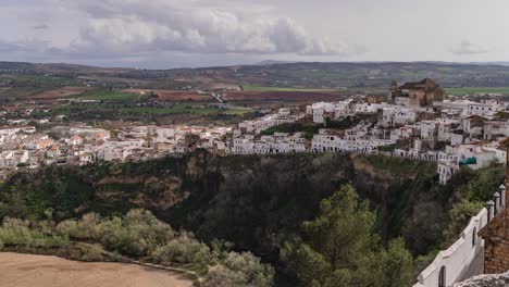 Tilt-up-time-lapse-over-beautiful-village-of-Arcos-de-la-frontera-in-Andalusia,-Spain