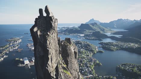 Person-trad-climbing-to-top-of-Svolværgeita-in-Norway,-Lofoten