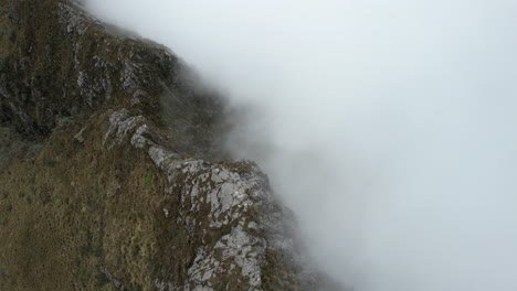 Aerial-View-of-Steep-Hills-and-Dense-Clouds-Under-Rucu-Pichincha-Volcano-Ecuador---Drone-Shot