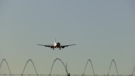Plane-landing-at-the-Burbank-Airport,-evening-in-Los-Angeles,-USA---Handheld-view