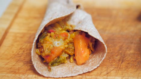 Stunning-close-up-of-homemade-mexican-fajitas-made-with-whole-wheat-tortilla-on-wooden-board