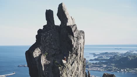 Single-person-climbing-on-extremely-dangerous-cliff-in-Norway,-Lofoten