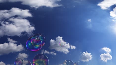 Soap-bubbles-flying-in-the-air-towards-the-clear-blue-sky-with-clouds-and-bright-sun
