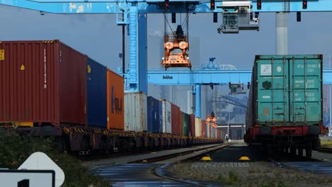 Blue-container-crane-moving-over-a-train-to-handle-the-containers