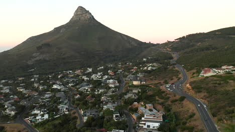 Aerial-View-Of-Scenic-Road-In-Camps-Bay-With-Lion's-Head-Mountain-In-South-Africa---drone-shot