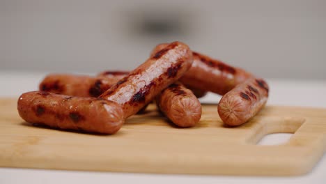 Perfectly-grilled-breakfast-sausage-drift-across-on-cutting-board-in-slow-motion