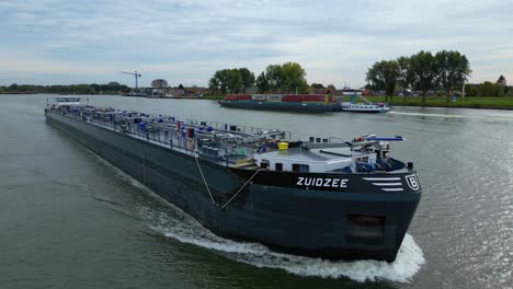 Zuidzee-Oil-Tanker-Sailing-Across-Oude-Maas-River-Near-Puttershoek-Village,-Western-Netherlands