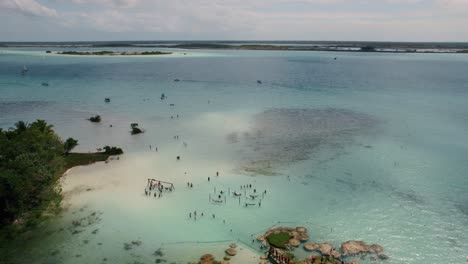 Aerial-over-touristic-beach-in-Bacalar,-Mexico