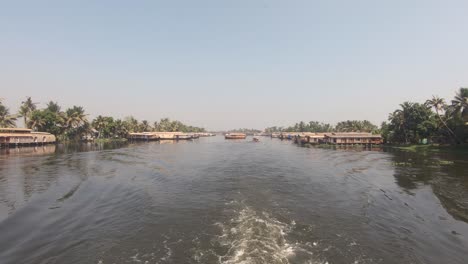 View-from-sailing-boat-of-houseboats-at-Alappuzha-or-Alleppey,-India
