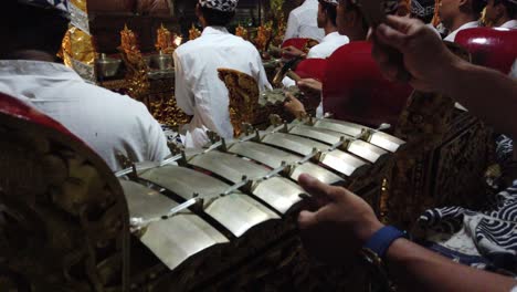 Gamelan-Bali-Ensemble-Gong-Kebyar,-Music-from-the-Island-of-Gods-Balinese-Player-Hammering-the-Keys-of-the-Bronze-Musical-Instrument