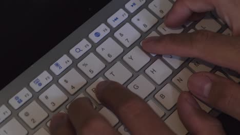 Hands-Typing-On-Wireless-Computer-Keyboard.-close-up