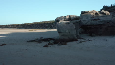 Rock-Formation-Found-on-a-Beach-in-Langebaan-Lagoon-at-West-Coast-National-Park,-South-Africa---Orbiting-Drone-Shot