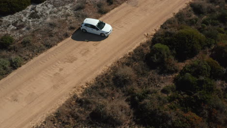 White-Car-Maneuvering-On-Dirt-Road-In-West-Coast-National-Park,-South-Africa