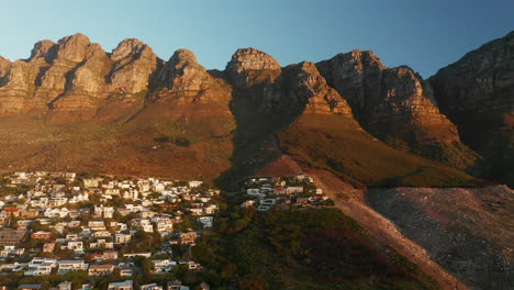 Twelve-Apostles-Mountain-And-Villas-At-Camps-Bay,-Cape-Town,-South-Africa---aerial-drone-shot