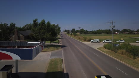 Shot-of-car-entering-Alon-Gas-Station-in-rural-Tulsa,-Oklahoma,-USA