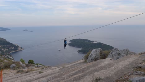 Girl-zip-lining-in-Dubrovnik,-Croatia.-Slow-motion