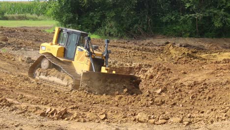 Caterpillar-D6T-Dozer-pushes-dirt-down-the-side-bank-while-preparing-a-site-for-a-new-pond-at-a-land-development-site
